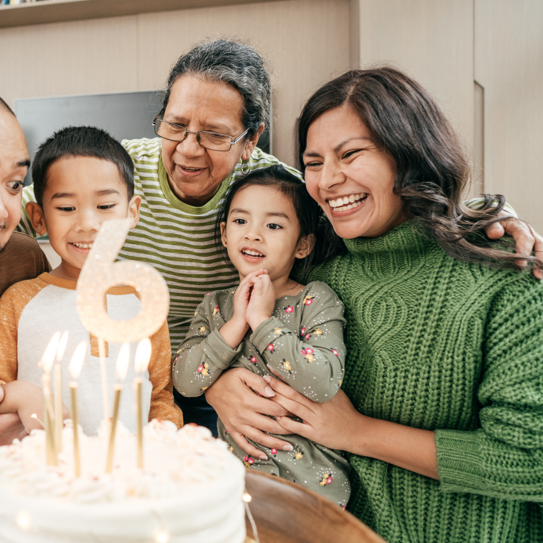 family in front of birthday cake